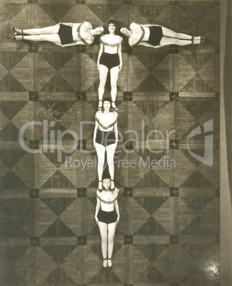 High angle view of women forming the letter "T"