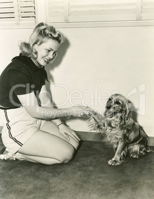 Shaking hands with her cocker spaniel