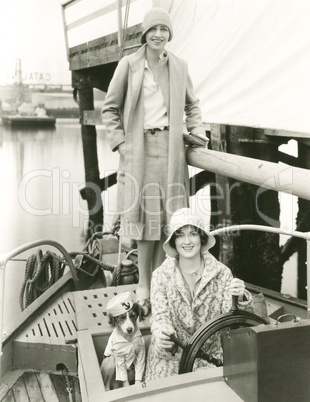 Two women out sailing with their mascot