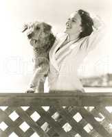 Woman posing with her Airedale at the beach