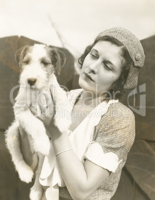 Young woman holding her wire-haired fox terrier