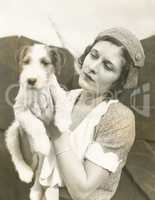 Young woman holding her wire-haired fox terrier