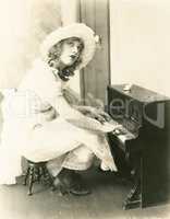 Woman playing a miniature piano