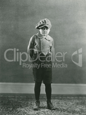 Boy posing with hands behind back