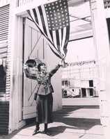 Female soldier holding American flag