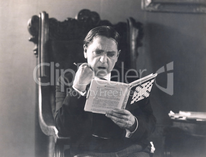 Man absorbed in crossword puzzle