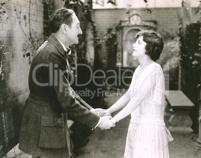 Happy couple holding hands outdoors