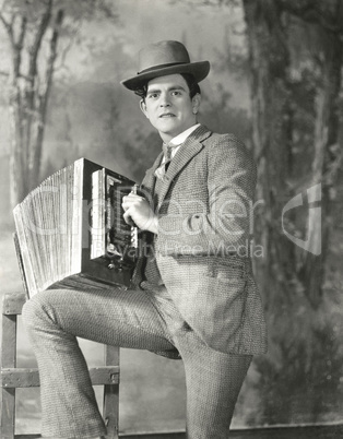 Portrait of young man playing accordion
