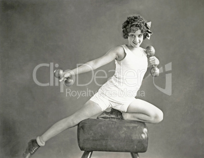 Woman doing arm exercises on vaulting horse