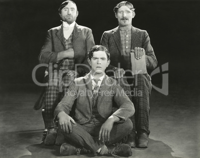 Three men posing in their Sunday best