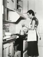Woman preparing food in double broiler