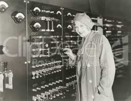 Woman taking a tour of 1930s recording studio