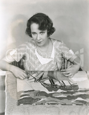 Woman making a hooked rug