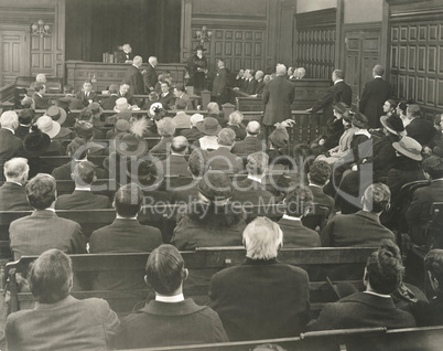 People sitting on benches in courtroom