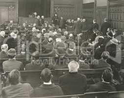 People sitting on benches in courtroom