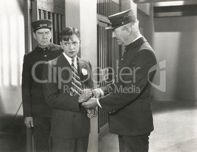 Guard removing handcuffs from prisoner