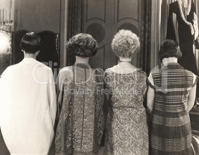 Rear view of four women standing in a row