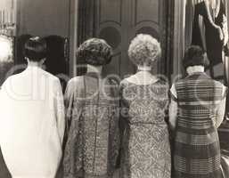Rear view of four women standing in a row