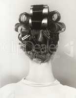 Rear view of woman with curlers in her hair