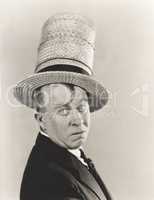 Man wearing stovepipe straw hat
