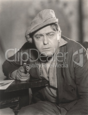 Portrait of despondent man pointing gun