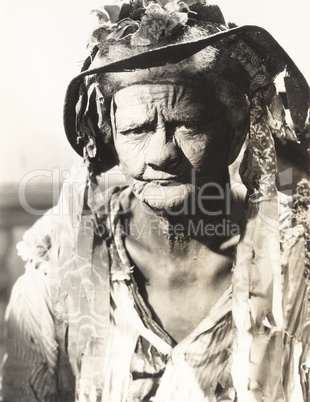 Portrait of frowning woman wearing torn hat