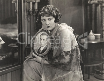 Woman holding framed photo of her loved one