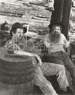 Two bearded men lounging