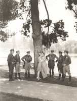 Police officers surrounding romantic couple in park