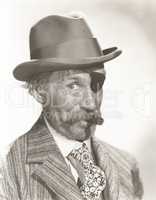 Man wearing eye patch and fedora smoking cigar