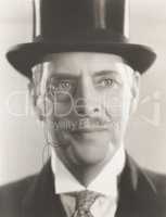 Portrait of man wearing monocle and top hat