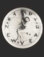 Woman sitting on huge Happy New Year clock
