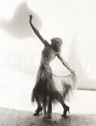 Dancer with arms outstretched against white background