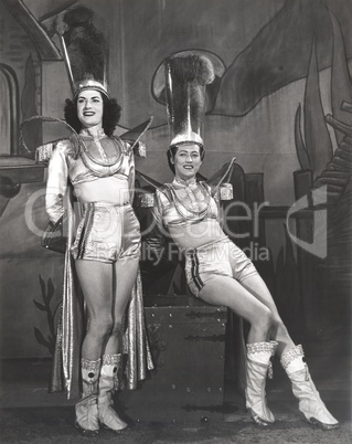 Two performers dressed in magician assistant costumes
