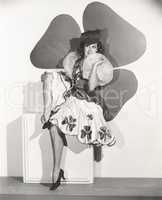 Woman posing in four-leaf clover costume
