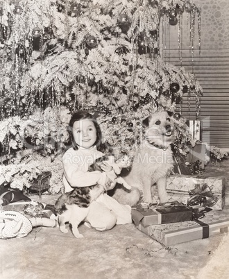 Little girl receives a cat and dog for Christmas