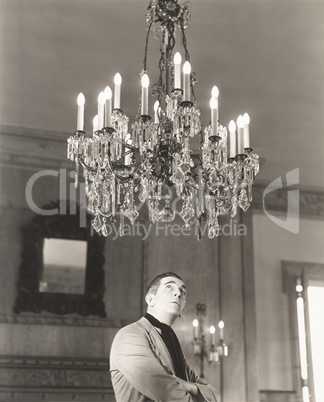 Man staring at chandelier