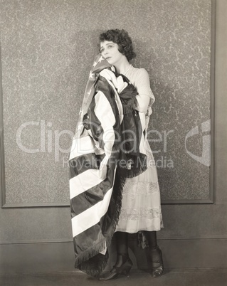 Woman holding American flag against her cheek