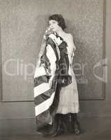 Woman holding American flag against her cheek