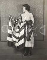 Woman with draped American flag over her arms