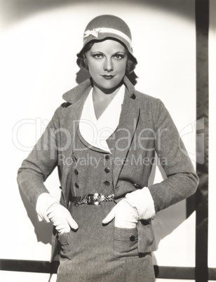 Woman wearing dress suit with matching hat