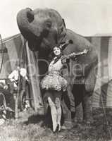 Circus performer posing with elephant