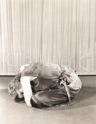 Woman curled up on floor