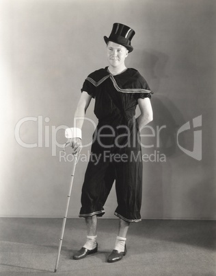 Man posing in cuffs, top hat and circus costume