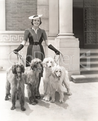 A woman and her four Afghan Hounds