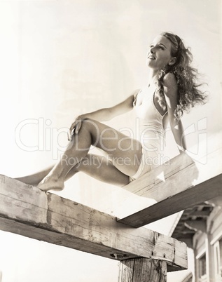 Woman sunbathing on a pier