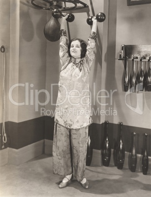 Woman exercising in silk pajamas