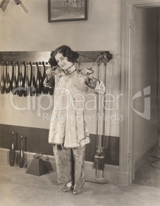 Woman in silk pajamas exercising in gym