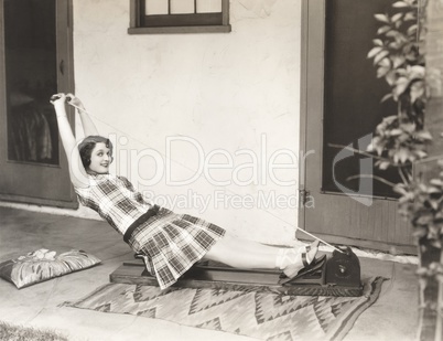 Woman using rowing machine at home