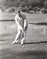 Man playing golf at country club